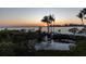 Beautiful fountain reflecting the sunset on the water near luxury homes and lush tropical foliage at 3935 N Shell Rd, Sarasota, FL 34242