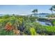 Stunning waterfront view showcases lush tropical foliage and tranquil blue waters in a serene setting at 3935 N Shell Rd, Sarasota, FL 34242