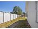 White fenced backyard featuring gravel and a cozy firepit area under a pergola, perfect for outdoor entertaining at 4003 3Rd Nw Ave, Bradenton, FL 34209