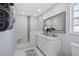 Elegant bathroom featuring a large walk-in shower, double vanity, and stylish mirror at 4003 3Rd Nw Ave, Bradenton, FL 34209