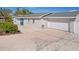 Home exterior featuring a spacious driveway leading to a garage and side entry, complemented by manicured landscaping at 4003 3Rd Nw Ave, Bradenton, FL 34209