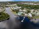 An aerial view shows the beautiful community with a pool, docks, and clubhouse along a scenic river at 428 Islebay Dr, Apollo Beach, FL 33572