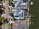 Aerial view showcasing a home with a modern roof, a screened-in pool, and waterfront access with a private dock at 428 Islebay Dr, Apollo Beach, FL 33572