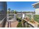 Back yard features a gated access, with waterfront views, tropical plants and manicured landscaping at 428 Islebay Dr, Apollo Beach, FL 33572