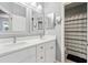 Bathroom featuring double sinks with white countertops, and vanity mirrors, with a combined tub and shower at 428 Islebay Dr, Apollo Beach, FL 33572