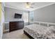 Comfortable bedroom with a ceiling fan, dark wood dresser, carpet floors, and a window with bright natural light at 428 Islebay Dr, Apollo Beach, FL 33572