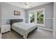 Comfortable bedroom featuring a cozy bed, bright windows overlooking lush greenery, and soothing wall colors at 428 Islebay Dr, Apollo Beach, FL 33572