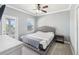Bedroom features a large bed, neutral decor, ceiling fan, and private access to a balcony with nice natural light at 428 Islebay Dr, Apollo Beach, FL 33572