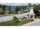 A community entrance with lush landscaping and a view of the lake at 428 Islebay Dr, Apollo Beach, FL 33572