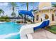 Community pool featuring a water slide, seating and tropical landscaping at 428 Islebay Dr, Apollo Beach, FL 33572