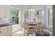 Bright dining area features many windows, a wood table, and views of palm trees outside at 428 Islebay Dr, Apollo Beach, FL 33572