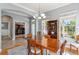 Open dining room features a wood table, decorative shelving, gray walls, and natural light through large windows at 428 Islebay Dr, Apollo Beach, FL 33572