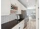 Bright kitchen area featuring a wine rack, coffee machine and stainless steel refrigerator at 428 Islebay Dr, Apollo Beach, FL 33572