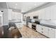 Bright kitchen with white cabinets, stainless steel appliances, and dark countertops at 428 Islebay Dr, Apollo Beach, FL 33572