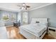 Spacious main bedroom with hardwood floors, desk, and private bathroom access at 428 Islebay Dr, Apollo Beach, FL 33572