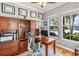 Inviting home office space with hardwood floors, built-in shelving, and natural light at 428 Islebay Dr, Apollo Beach, FL 33572
