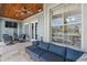 Covered patio with wood ceiling, ceiling fan, and comfortable seating, perfect for relaxing and entertaining guests at 428 Islebay Dr, Apollo Beach, FL 33572