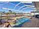 Gorgeous waterfront pool and spa with screened enclosure, offering stunning views of the canal at 428 Islebay Dr, Apollo Beach, FL 33572