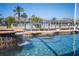 Inviting pool with waterfall feature and in-water seating, set against a backdrop of waterfront homes at 428 Islebay Dr, Apollo Beach, FL 33572