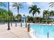 Community pool with water fountain feature and chairs surrounded by palm trees at 428 Islebay Dr, Apollo Beach, FL 33572