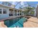 Gorgeous pool and spa with swim up bar in a screened enclosure, complemented by an outdoor seating area at 428 Islebay Dr, Apollo Beach, FL 33572