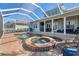 Inviting pool and spa in a screened enclosure with an outdoor seating area, perfect for relaxation and entertaining at 428 Islebay Dr, Apollo Beach, FL 33572