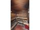 Cozy, wood-lined sauna room, featuring built-in benches and traditional sauna accessories at 428 Islebay Dr, Apollo Beach, FL 33572