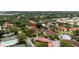 Aerial view of the complex with a red marker, pool, tennis court, and several ponds at 4330 47Th W Ave # 104, Bradenton, FL 34210