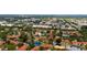 Aerial view of the complex with a red marker, pool, tennis court, and several ponds at 4330 47Th W Ave # 104, Bradenton, FL 34210