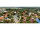 Aerial view of the complex with a red marker, pool, tennis court, and several ponds at 4330 47Th W Ave # 104, Bradenton, FL 34210