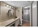 The bathroom features a vanity, and a walk-in shower behind a glass door at 4330 47Th W Ave # 104, Bradenton, FL 34210