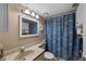 Bathroom with a coordinated blue palm shower curtain and a stylish star fish decoration for beachy vibe at 4330 47Th W Ave # 104, Bradenton, FL 34210