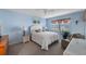 Light-filled bedroom with a queen bed, neutral tones, and a large window offering natural light at 4330 47Th W Ave # 104, Bradenton, FL 34210