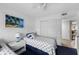 Bright guest bedroom with twin beds, coastal themed bedding, closet and white furnishings at 4330 47Th W Ave # 104, Bradenton, FL 34210