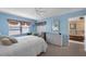 Bright bedroom boasts a queen bed, wicker furnishings, and neutral tones with an adjacent sitting area at 4330 47Th W Ave # 104, Bradenton, FL 34210