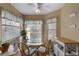 Sunlit breakfast nook with a glass table, four chairs, and three large windows for ample natural light at 4330 47Th W Ave # 104, Bradenton, FL 34210