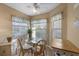 Cozy breakfast nook featuring a glass table, four chairs, and bright natural light from surrounding windows at 4330 47Th W Ave # 104, Bradenton, FL 34210