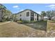 Spacious condo building featuring a screened lanai and lush landscaping at 4330 47Th W Ave # 104, Bradenton, FL 34210