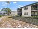Exterior of a condo building featuring screened lanais and mature landscaping at 4330 47Th W Ave # 104, Bradenton, FL 34210
