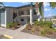 Inviting condo exterior featuring landscaped grounds and well-maintained facade under a clear, sunny sky at 4330 47Th W Ave # 104, Bradenton, FL 34210