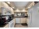 Bright kitchen features granite countertops, white appliances and cabinets, and a pass-through window at 4330 47Th W Ave # 104, Bradenton, FL 34210