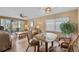 A view of the living area with comfortable seating and a glass table near screened patio doors at 4330 47Th W Ave # 104, Bradenton, FL 34210