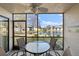 View of the screened patio with seating area overlooking the landscaped community and lake at 4330 47Th W Ave # 104, Bradenton, FL 34210