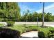 Charming front yard featuring brick-lined flowerbeds and a birdbath amongst lush landscaping at 436 Country Ln, Bradenton, FL 34212