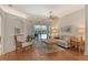 Bright living room with hardwood floors, neutral decor, and a ceiling fan, opening to the pool area at 436 Country Ln, Bradenton, FL 34212