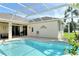 Sparkling in-ground pool with screened enclosure, sun deck, and outdoor seating at 436 Country Ln, Bradenton, FL 34212