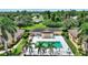 Aerial view of a townhouse with a private pool, parking and landscaping at 4790 Turnberry Cir, North Port, FL 34288