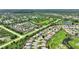 Aerial view of a large townhouse community with a pond and mature trees at 4790 Turnberry Cir, North Port, FL 34288