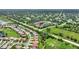Aerial view of a townhouse community with a pond and mature trees at 4790 Turnberry Cir, North Port, FL 34288