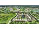 Aerial view of a townhome community with mature trees and landscaping near lakes and nature preserves at 4790 Turnberry Cir, North Port, FL 34288